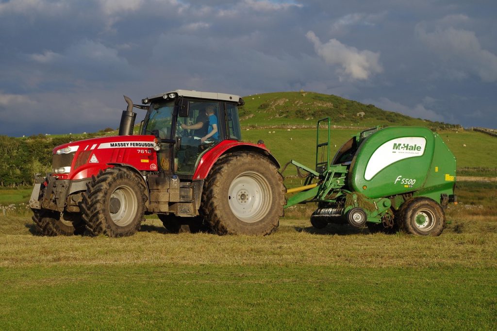 modern agriculture machinery operating in wheat field